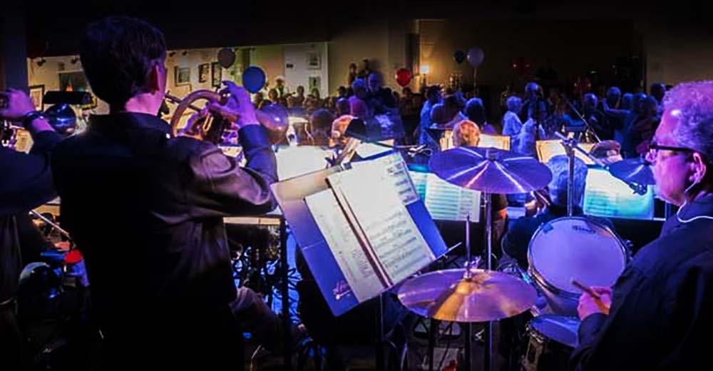 View of the crowd at a coorporate event from behind the Long Island Jazz Orchestra.
